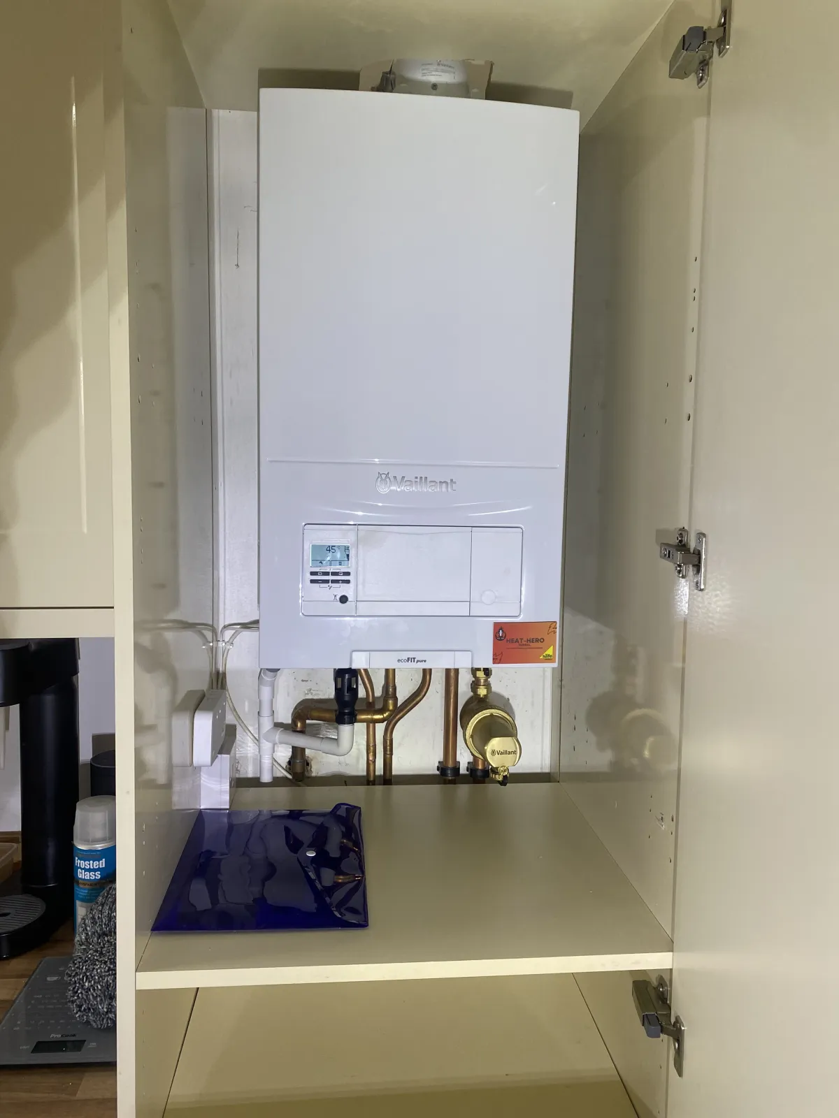 Vaillant combi boiler in a kitchen cupboard, serviced by Heat Hero Wirral