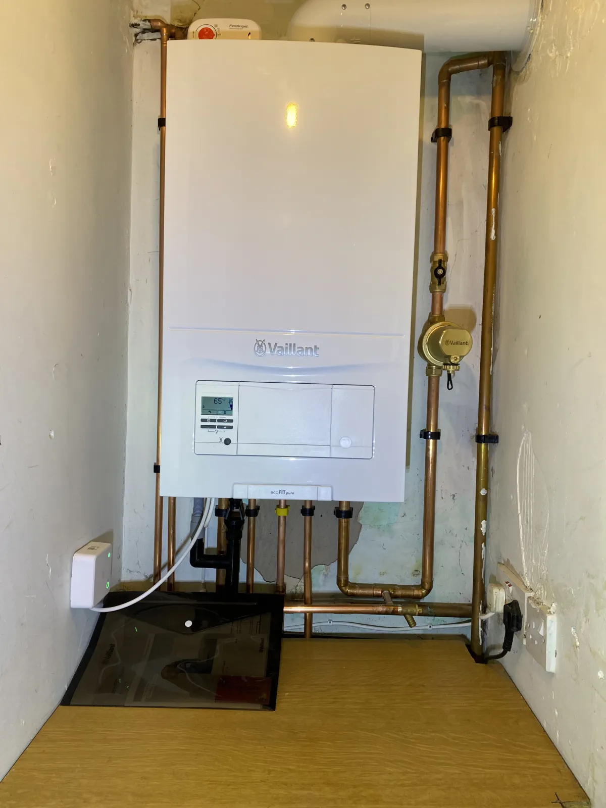 Vaillant ecoFIT combi boiler installed in a utility recess with new copper pipework and system filter
